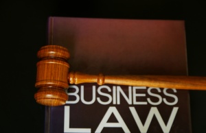 Business Law - picture of a business law contract with gavel on top of corporate law book